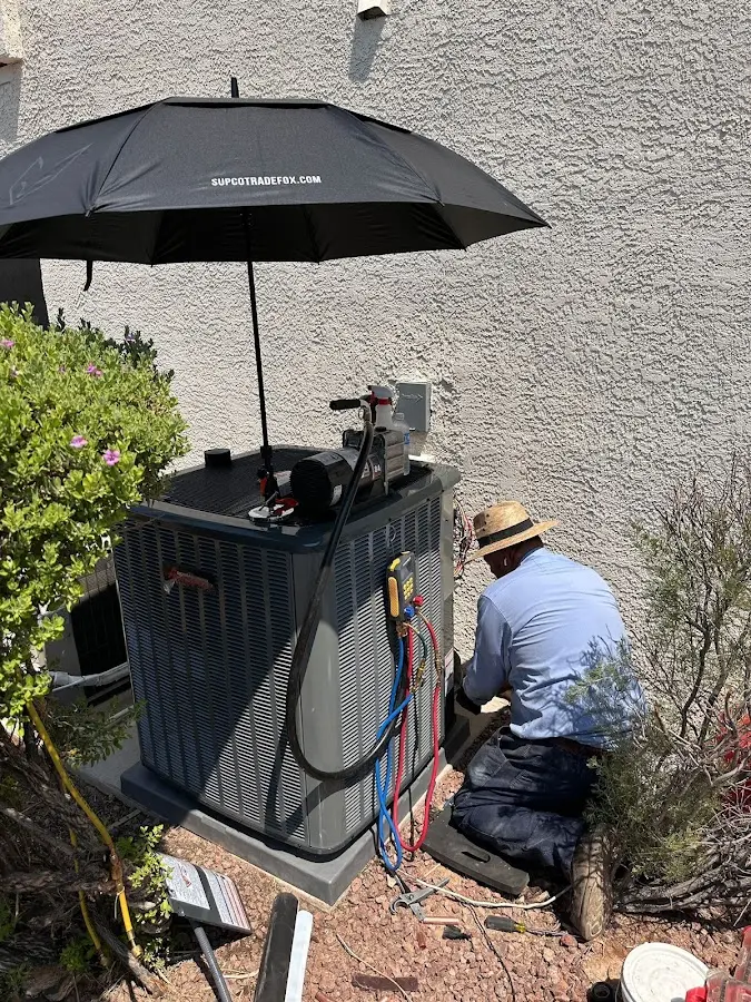 HVAC technician performing outdoor AC maintenance in Eastham